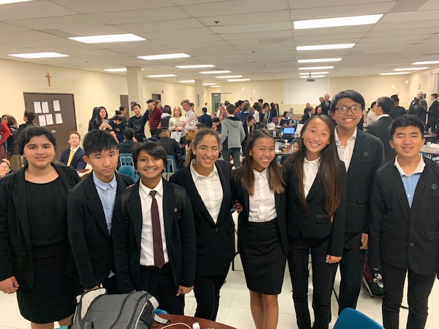 A group of students smiling at a debate competition - Cogito Debate